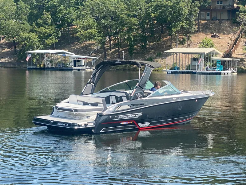 Slide: The Image of 2021 Monterey 278SS boat on a serene lake with lush green trees. - 3