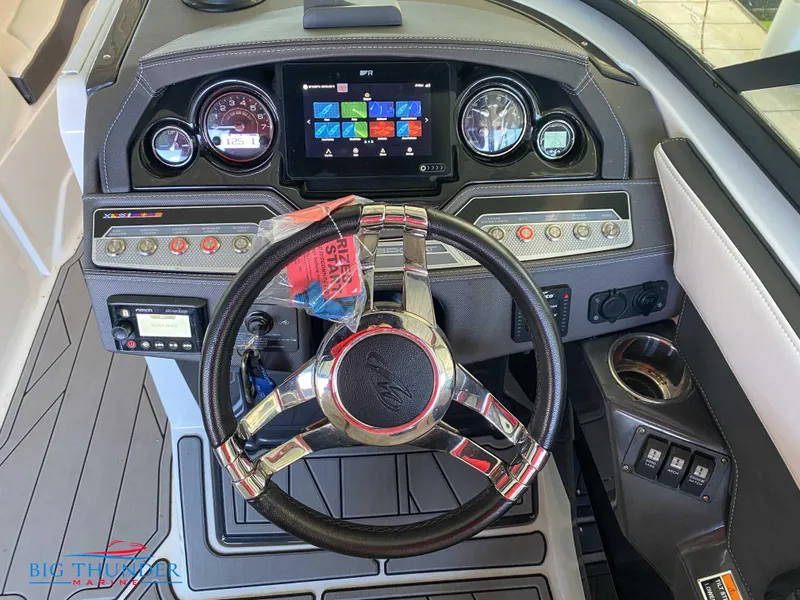 Slide: The Image of 2021 Monterey 278SS boat dashboard with steering wheel, gauges, and touchscreen display. - 30