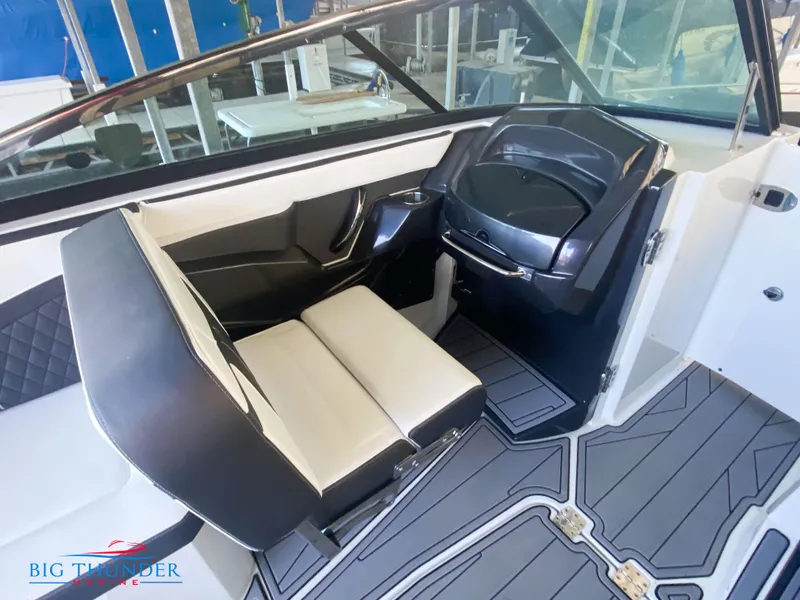 Slide: The Image of 2021 Monterey 278SS boat interior with black and white seating and modern dashboard. - 38