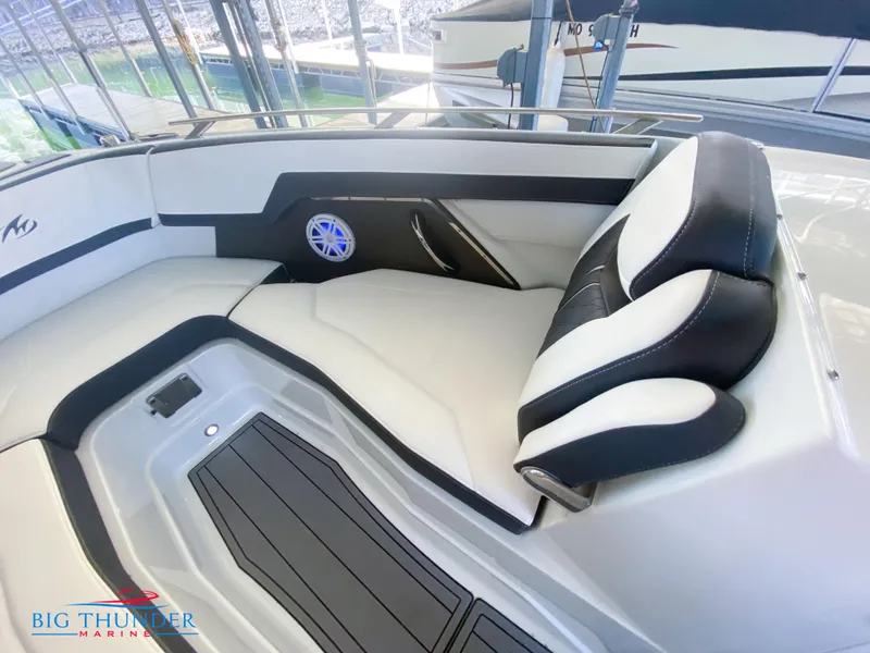 Slide: The Image of 2021 Monterey 278SS boat interior with white and black seating, speaker, and Big Thunder Marine logo. - 42