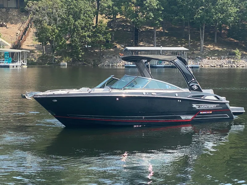 Slide: The Image of 2021 Monterey 278SS boat on a calm lake with wooded shoreline. - 5