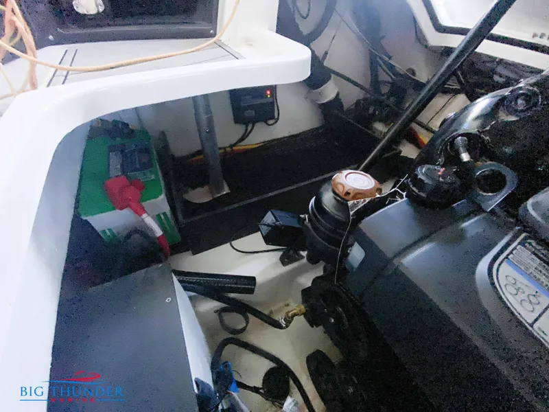 Slide: The Image of Engine compartment of a 2021 Monterey 278SS boat with visible battery and engine components. - 51