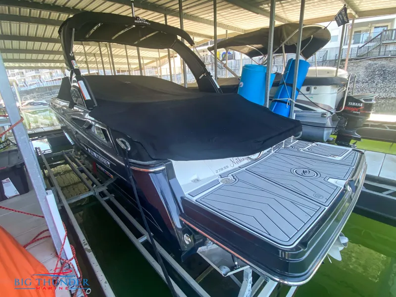 Slide: The Image of 2021 Monterey 278SS boat docked under a covered marina. - 54