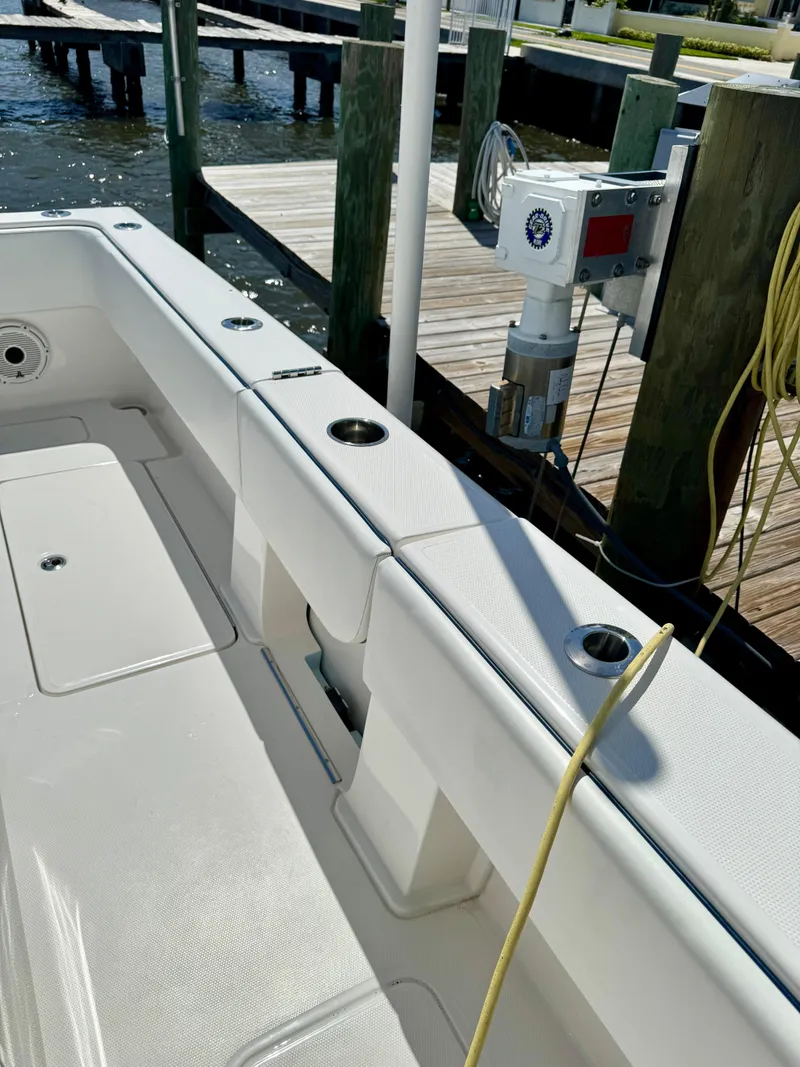 Slide: The Image of 2020 Invincible 36' Open Fisherman boat docked, showing clean deck and fishing rod holders. - 18