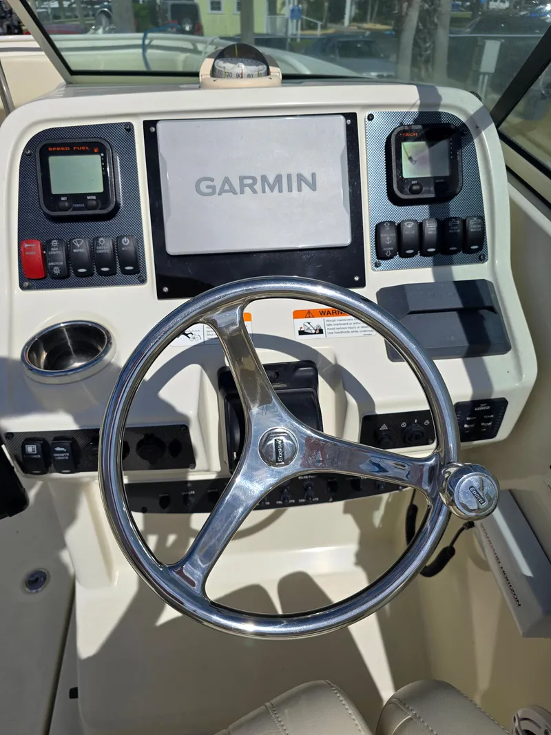 Slide: The Image of 2008 Hydra-Sports Vector 2200 DC dashboard with Garmin navigation and steering wheel. - 13