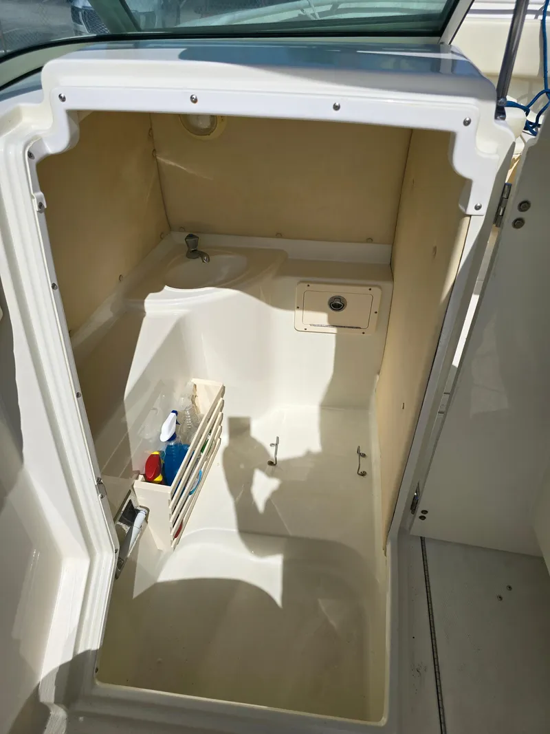 Slide: The Image of 2008 Hydra-Sports Vector 2200 DC boat interior storage compartment with cleaning supplies. - 20