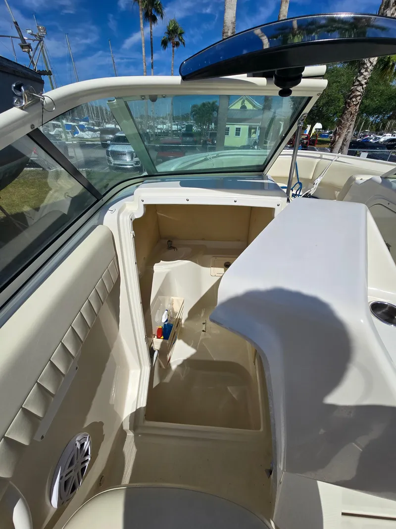 Slide: The Image of 2008 Hydra-Sports Vector 2200 DC boat interior with open storage compartment and clear windshield. - 21