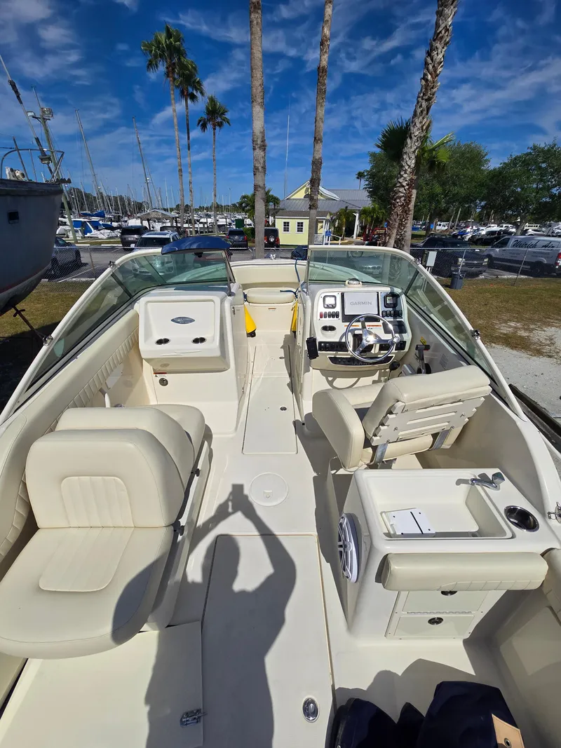Slide: The Image of 2008 Hydra-Sports Vector 2200 DC boat interior with seating and steering console, docked under blue sky. - 22