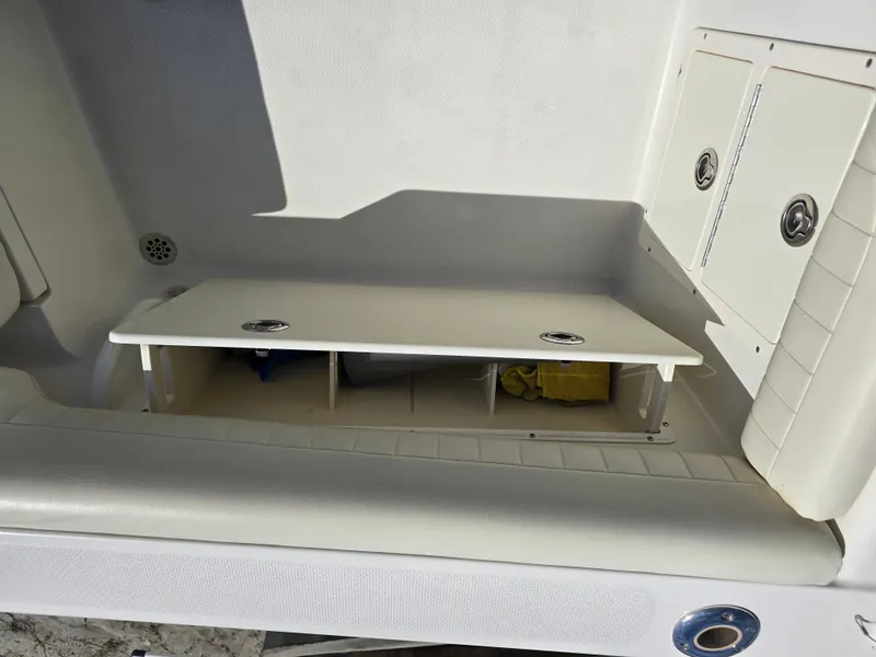 Slide: The Image of 2008 Hydra-Sports Vector 2200 DC boat storage compartment with open hatch and seating area. - 28