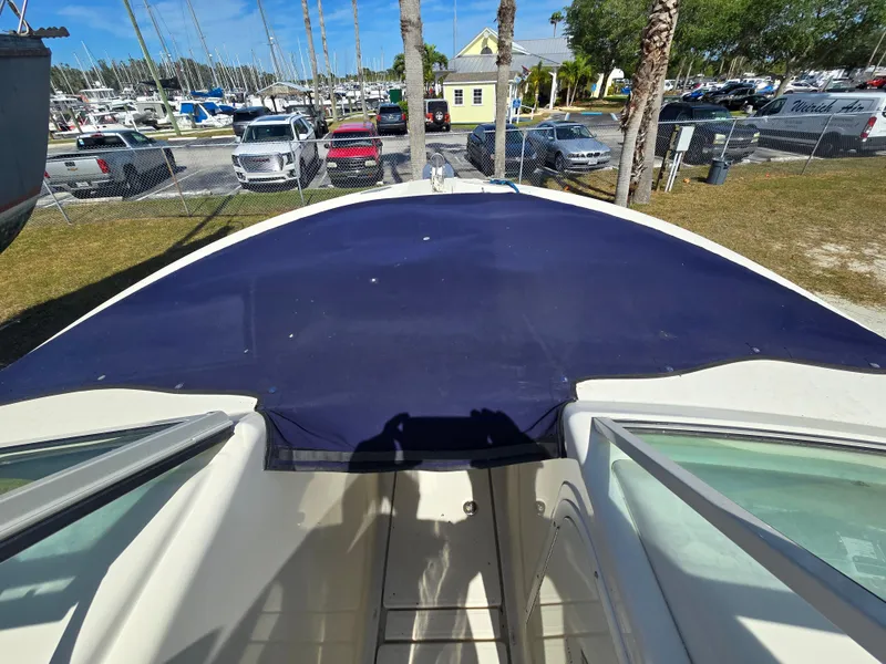Slide: The Image of 2008 Hydra-Sports Vector 2200 DC boat with blue cover, parked near marina. - 3