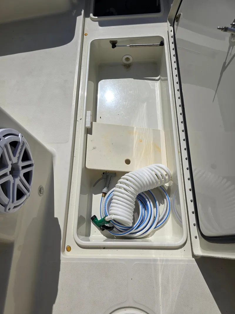 Slide: The Image of Storage compartment on a 2008 Hydra-Sports Vector 2200 DC boat with coiled hose. - 36