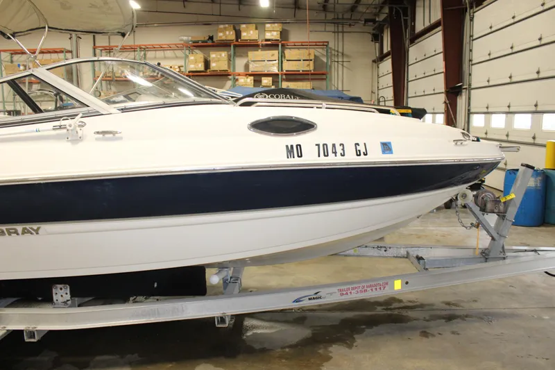 Slide: The Image of 2013 Stingray 208 CK boat on trailer in indoor storage facility. - 11