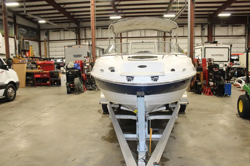 Slide: The Image of 2013 Stingray 208 CK boat on trailer in a warehouse. - 12