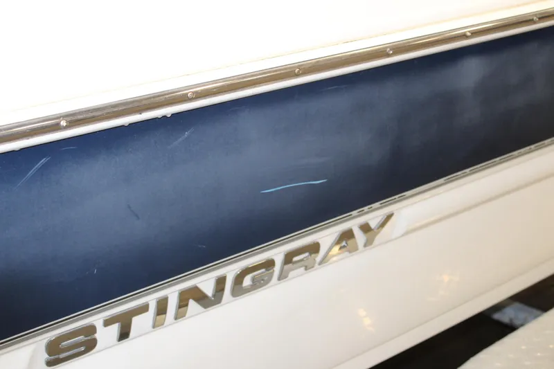 Slide: The Image of 2013 Stingray 208 CK boat side view with logo - 14