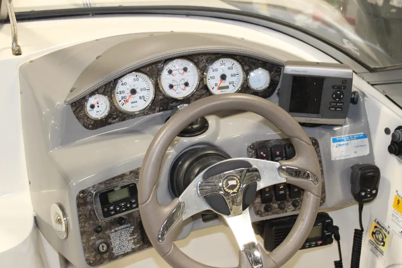 Slide: The Image of Dashboard of a 2013 Stingray 208 CK boat with gauges and controls. - 19