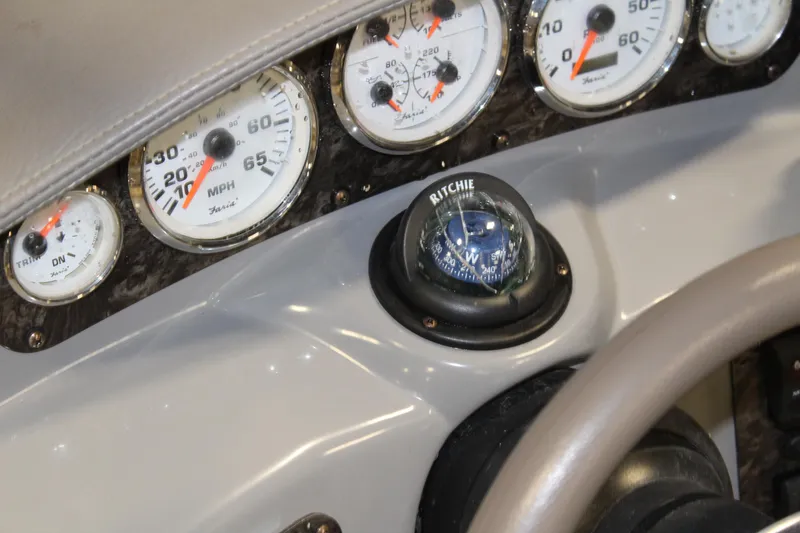 Slide: The Image of Dashboard of a 2013 Stingray 208 CK boat with gauges and compass. - 21