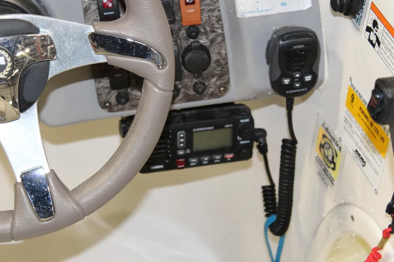 Slide: The Image of Close-up of 2013 Stingray 208 CK boat dashboard with steering wheel and radio equipment. - 24