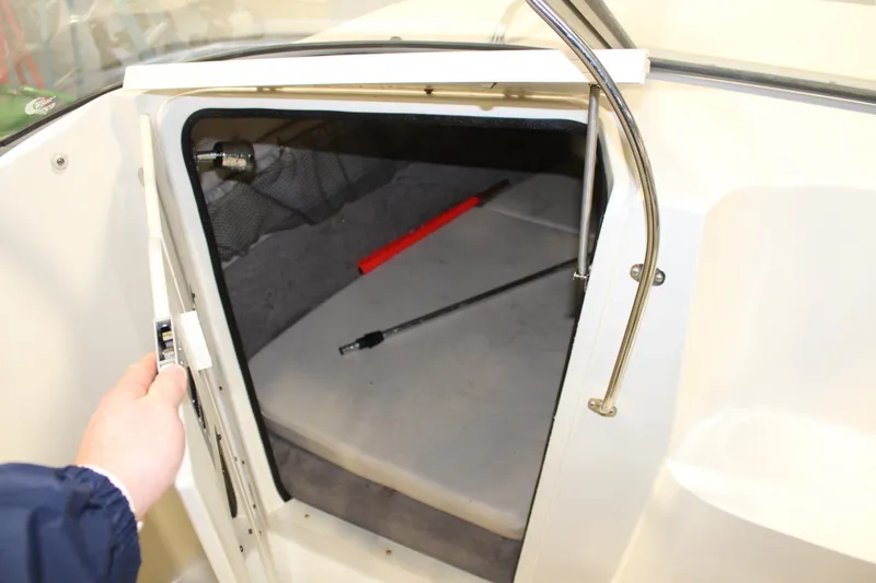 Slide: The Image of 2013 Stingray 208 CK boat cabin interior with open door. - 27