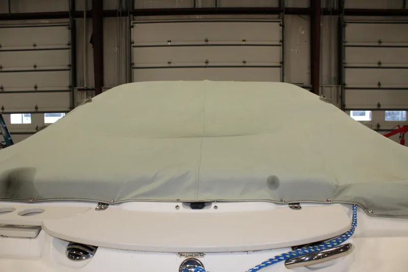 Slide: The Image of 2013 Stingray 208 CK boat with cover in a garage. - 3