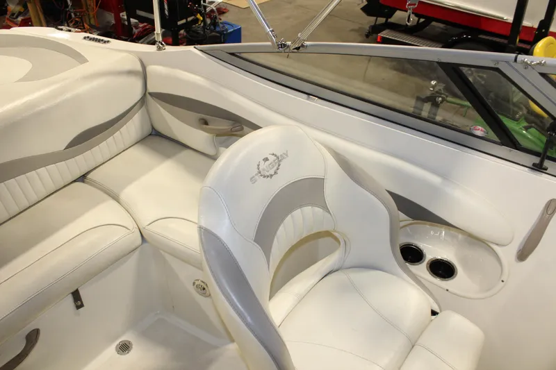 Slide: The Image of Interior of a 2013 Stingray 208 CK boat with white and gray seating. - 30