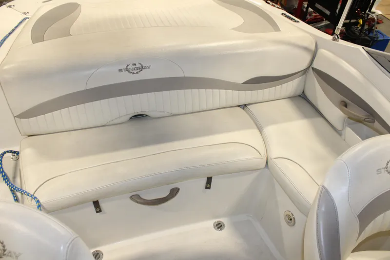 Slide: The Image of 2013 Stingray 208 CK boat interior seating area with white and gray upholstery. - 31