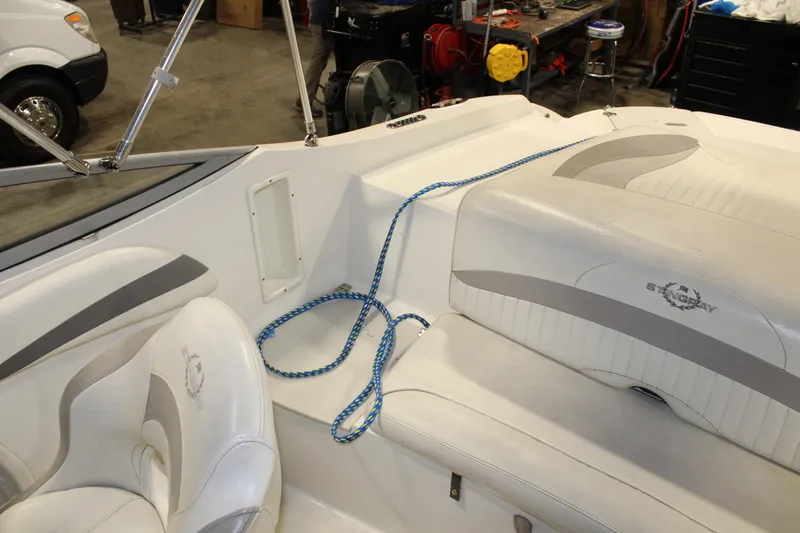 Slide: The Image of Interior of a 2013 Stingray 208 CK boat with white and gray seating. - 32