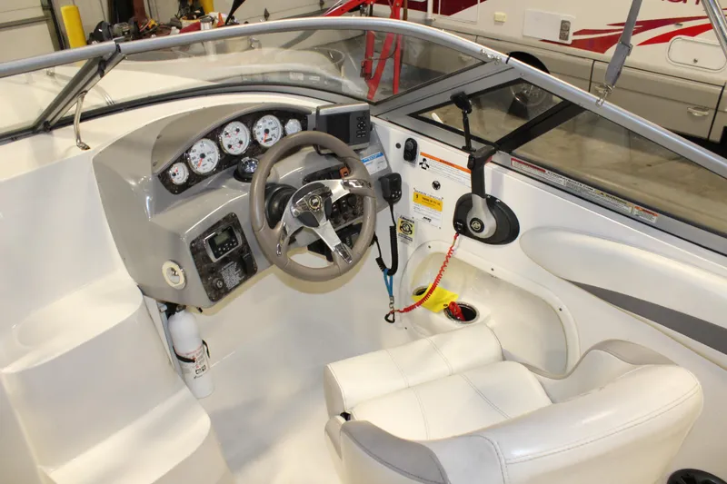 Slide: The Image of Interior cockpit of a 2013 Stingray 208 CK boat with steering wheel and control panel. - 33
