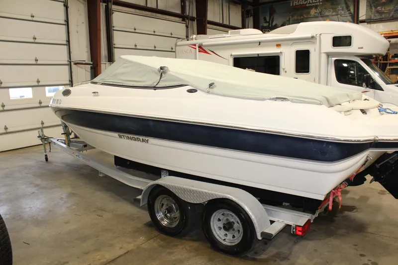 Slide: The Image of 2013 Stingray 208 CK boat on trailer in indoor storage. - 38