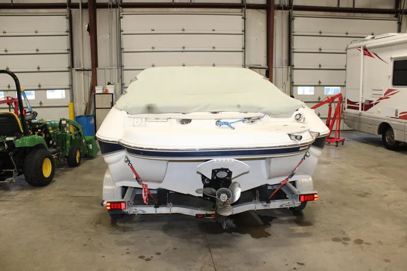 Slide: The Image of 2013 Stingray 208 CK boat in storage, covered and secured on a trailer. - 39