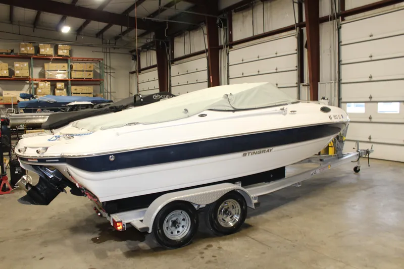 Slide: The Image of 2013 Stingray 208 CK boat on trailer in indoor storage facility. - 40