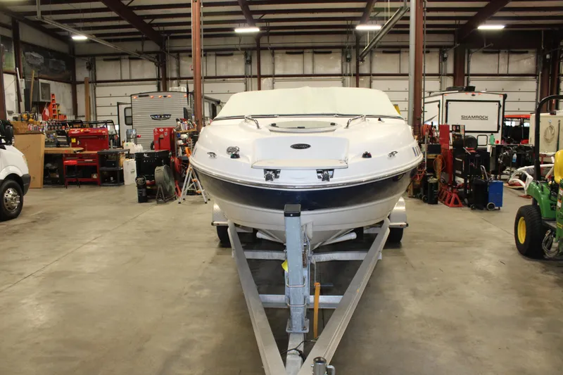 Slide: The Image of 2013 Stingray 208 CK boat in a workshop on a trailer. - 42