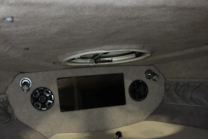 Slide: The Image of Interior cabin of a 2013 Stingray 208 CK boat with speakers and a hatch. - 43