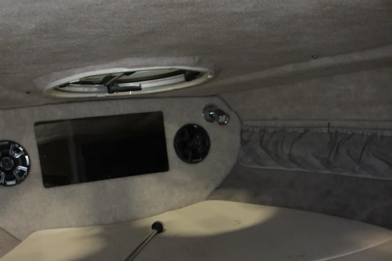 Slide: The Image of Interior cabin of a 2013 Stingray 208 CK boat with speakers and a hatch. - 44