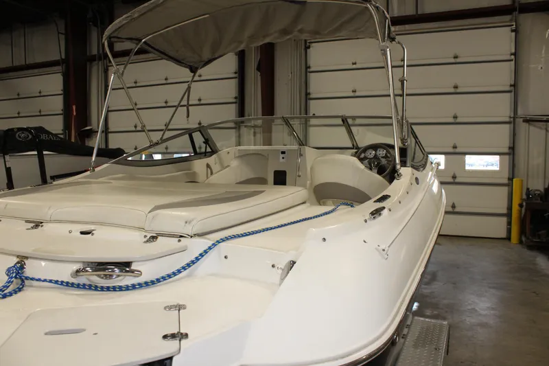 Slide: The Image of 2013 Stingray 208 CK boat in a storage facility. - 8