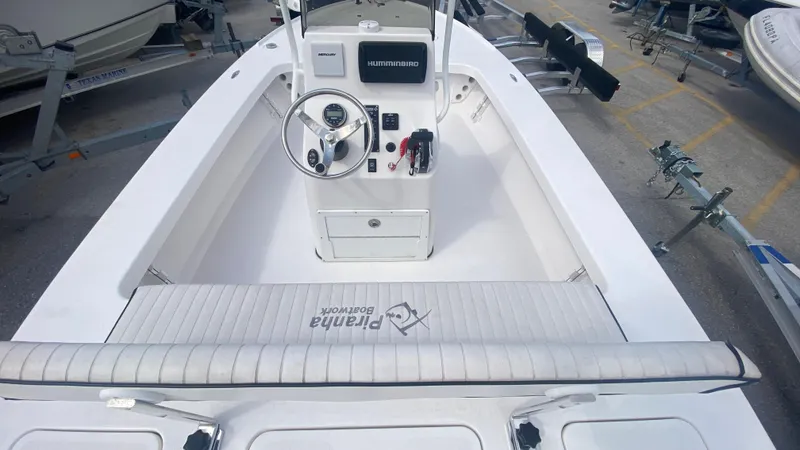 Slide: The Image of Piranha F2000 boat interior, 2025 model, featuring steering console and seating area. - 10