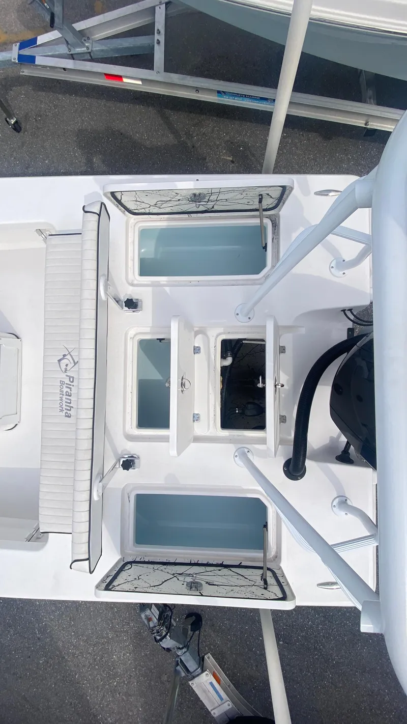 Slide: The Image of Piranha F2000 boat deck, 2025 model, featuring storage compartments and seating. - 13