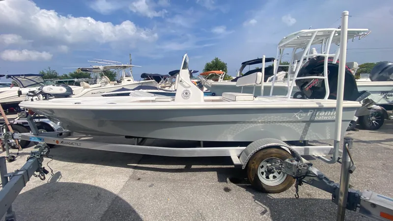 Slide: The Image of 2025 Piranha F2000 boat on trailer, parked outdoors under a blue sky. - 16