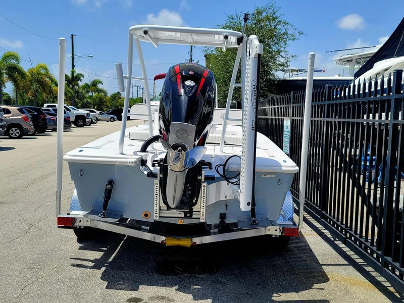 Slide: The Image of Piranha F2000 boat, 2025 model, parked on a sunny day near a fence. - 17