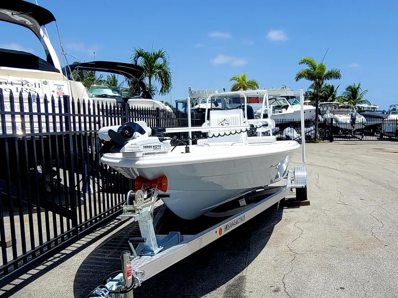 Slide: The Image of 2025 Piranha F2000 boat on trailer, parked near marina with palm trees. - 18