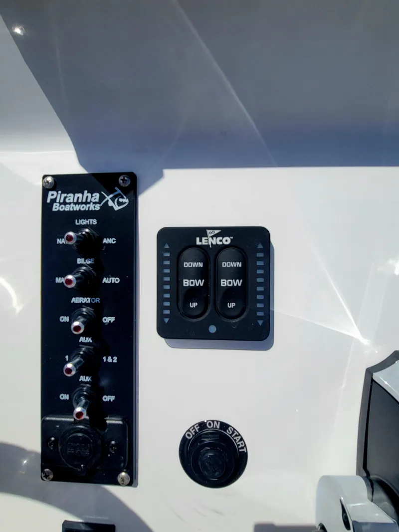 Slide: The Image of Control panel of Piranha F2000 boat, featuring Lenco trim tab switches. - 22