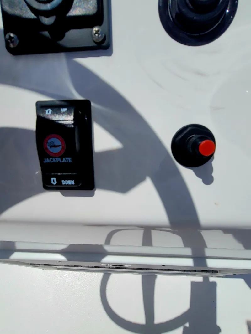 Slide: The Image of Control panel of Piranha F2000 boat, featuring jackplate switch and red button, 2025 model. - 24