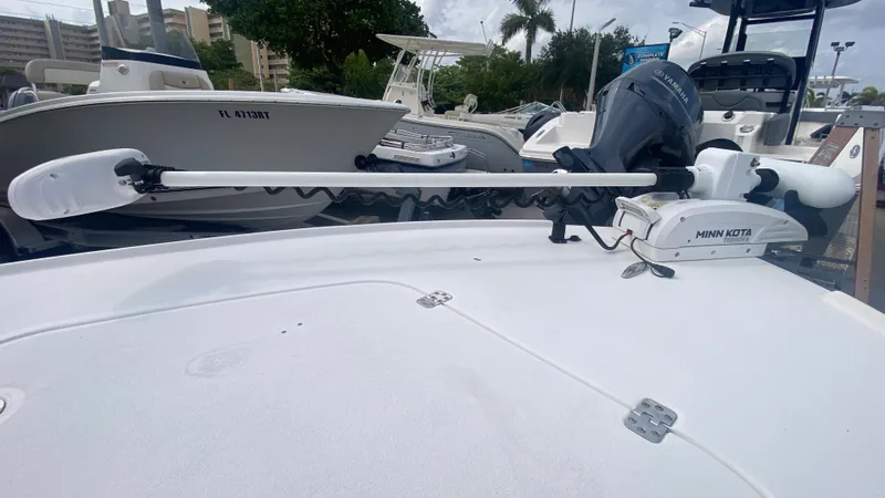 Slide: The Image of Boat deck featuring a Minn Kota trolling motor, Piranha F2000, 2025 model, in a marina setting. - 34
