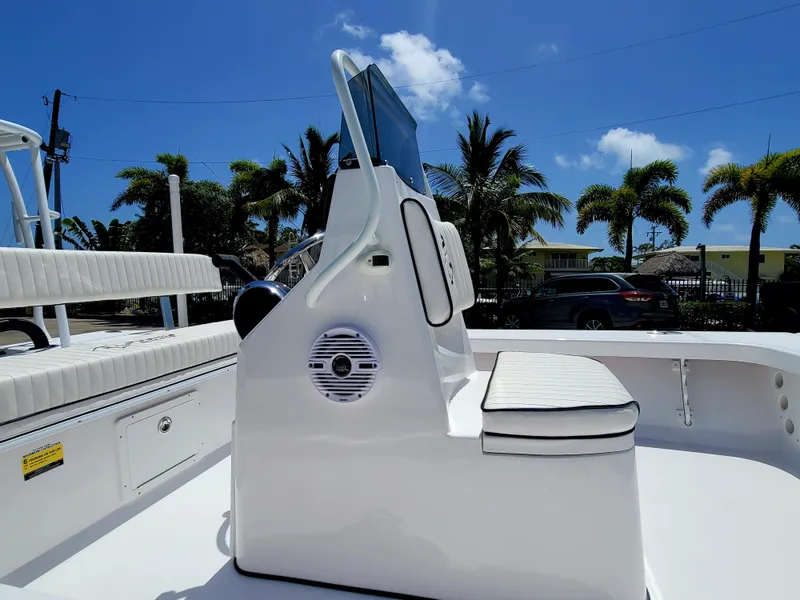 Slide: The Image of 2025 Piranha F2000 boat console with seating, set against a sunny, palm-lined backdrop. - 4