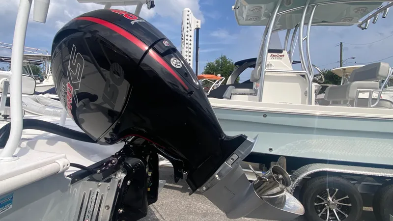 Slide: The Image of Piranha F2000 outboard motor on a boat, 2025 model, with sleek black and red design. - 7
