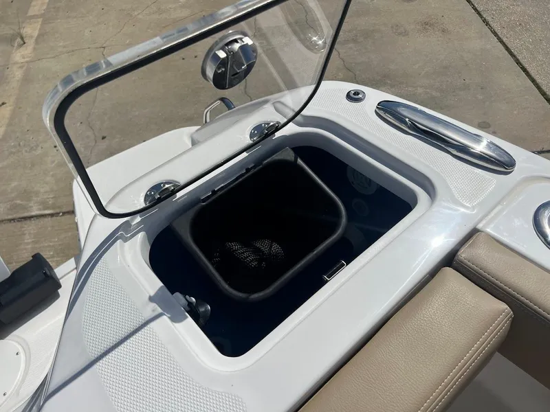 Slide: The Image of 2024 Everglades 315 Center Console livewell with open lid and net basket. - 10