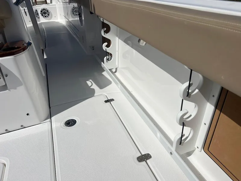 Slide: The Image of 2024 Everglades 315 Center Console boat interior with rod holders and storage compartments. - 12