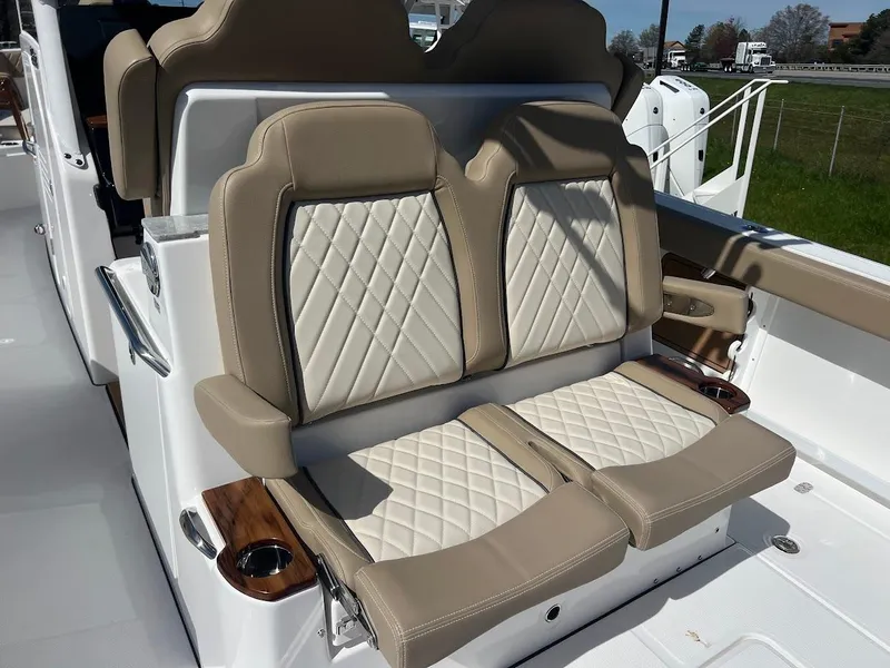 Slide: The Image of 2024 Everglades 315 Center Console boat with luxurious beige and white seating. - 14