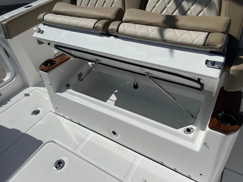 Slide: The Image of 2024 Everglades 315 Center Console boat with open storage compartment and cushioned seating. - 15