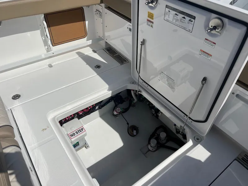 Slide: The Image of 2024 Everglades 315 Center Console boat storage compartment with open hatch. - 16