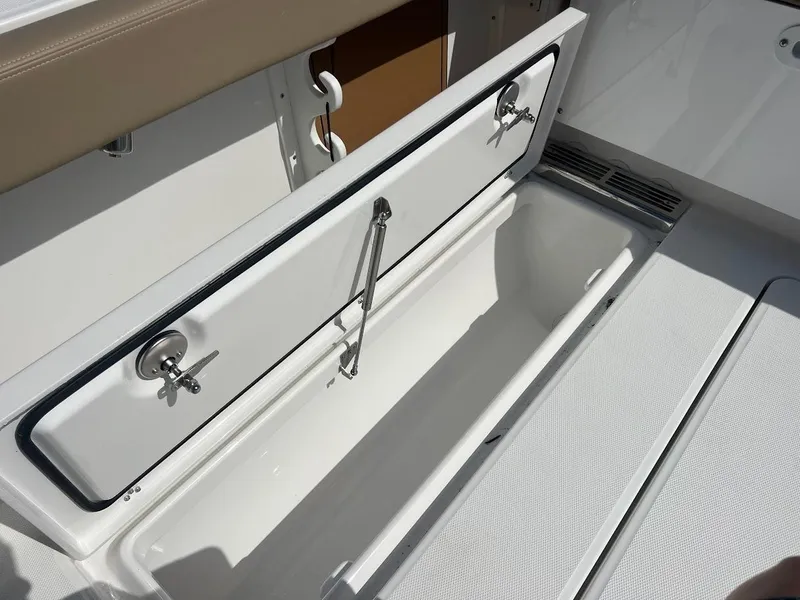 Slide: The Image of 2024 Everglades 315 Center Console storage compartment with open lid. - 17